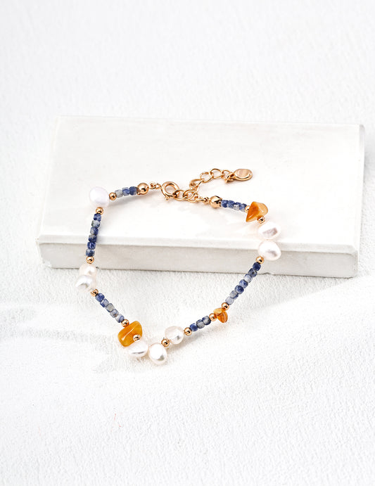 Unique bracelet made with natural pearls, blue spotted stones, and beeswax amber, blending earthy elegance