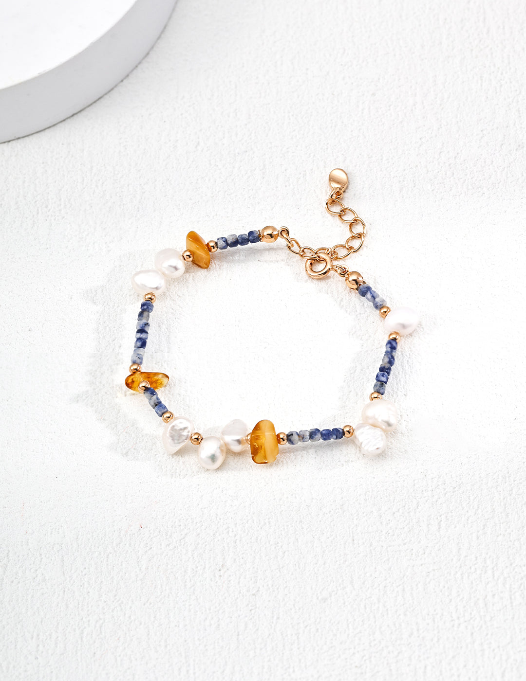 Elegant bracelet featuring natural pearls, blue spotted stones, and beeswax amber, perfect for a sophisticated look