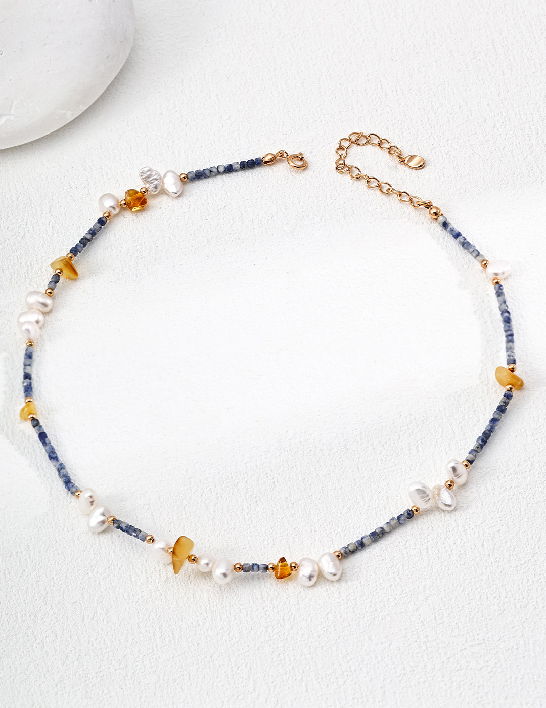 Timeless necklace made with natural pearls, blue spotted stones, and beeswax amber, perfect for a refined, nature-inspired aesthetic
