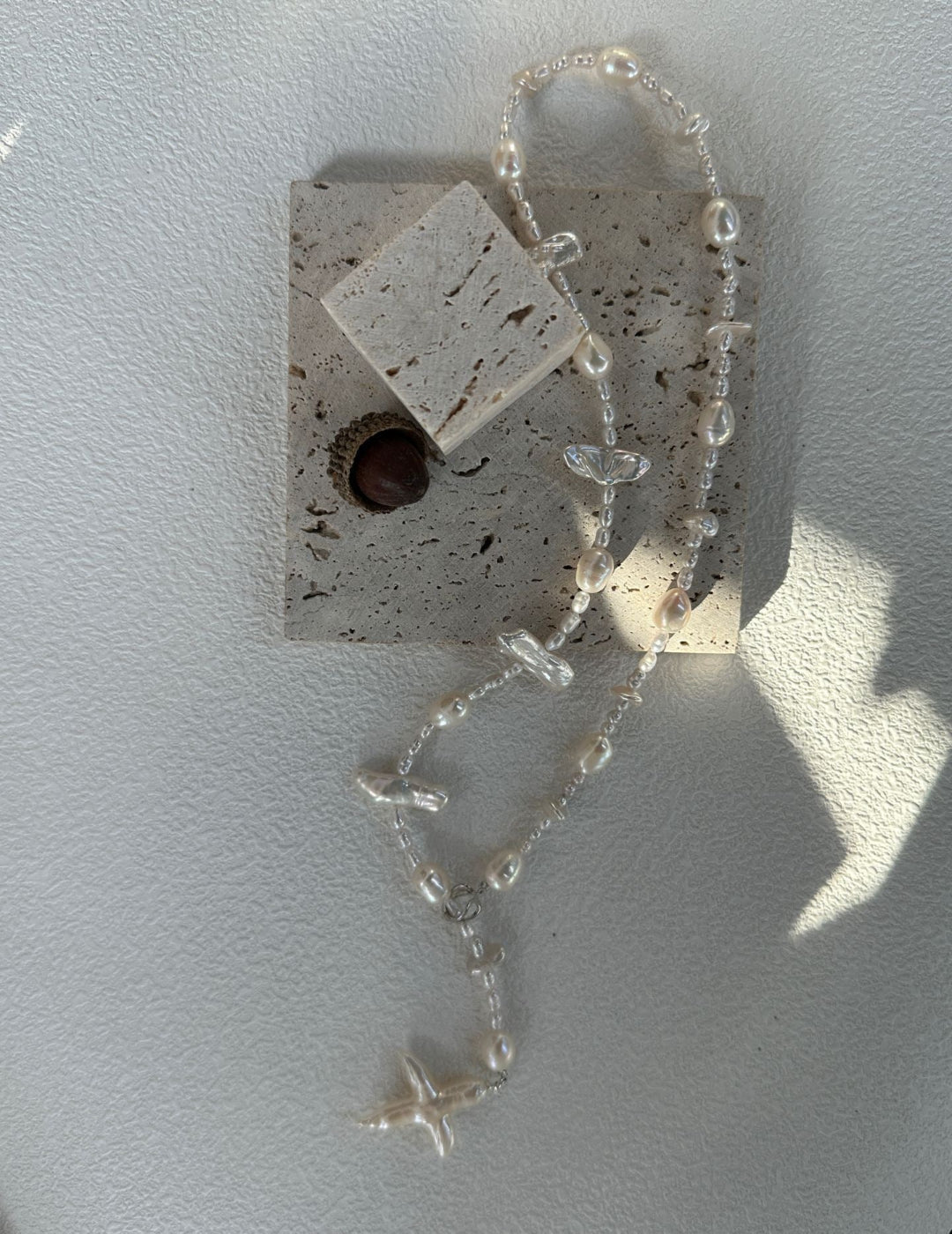 Charming handmade necklace with a cross pendant, adorned with uniquely shaped Baroque pearls, ideal for those seeking a distinctive and elegant accessory